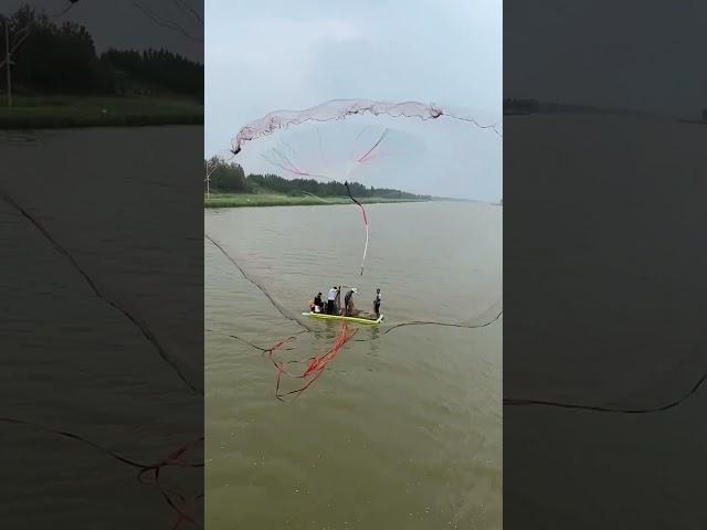 Throwing a Large Fishing Net into the River