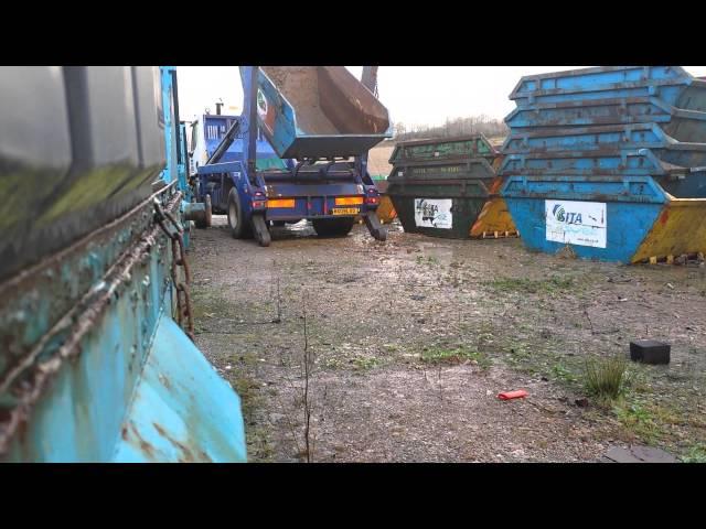 Skip lorry with skip full of water