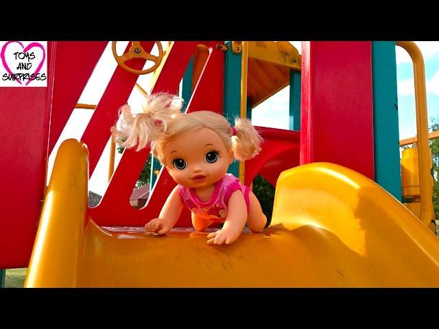 Baby Alive dolls play in the playground on slide and swings
