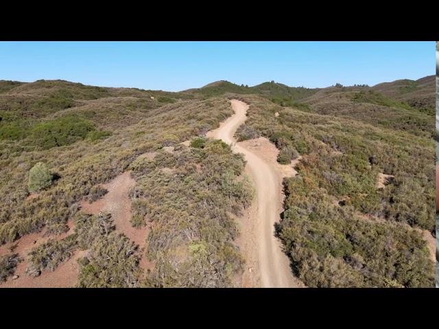 Dirt road with abandoned vehicle