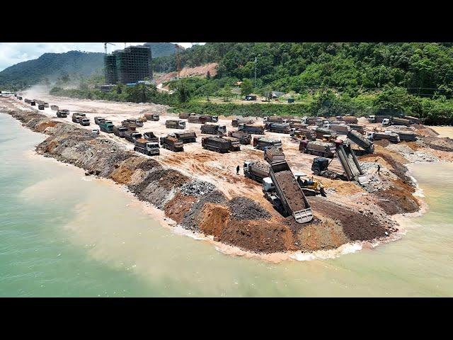 Huge Land Reclamation Process Dump Truck Management Unloading Rock Dirt Bulldozer Pushing Stone