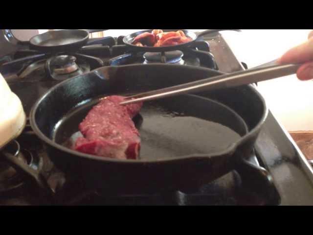 Cooking venison strip in a cast iron skillet