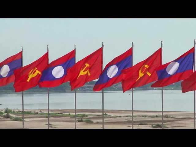 Lao and Communist flag vawing  Vientiane Riverfront 2012.