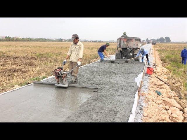 Construction A Concrete Road Stretching On Rural Fields With Ready-Mixed Concrete