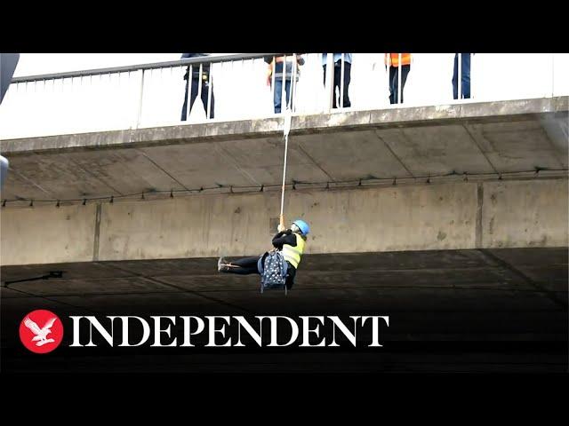 Climate activist hangs from Adelaide bridge during Extinction Rebellion protest