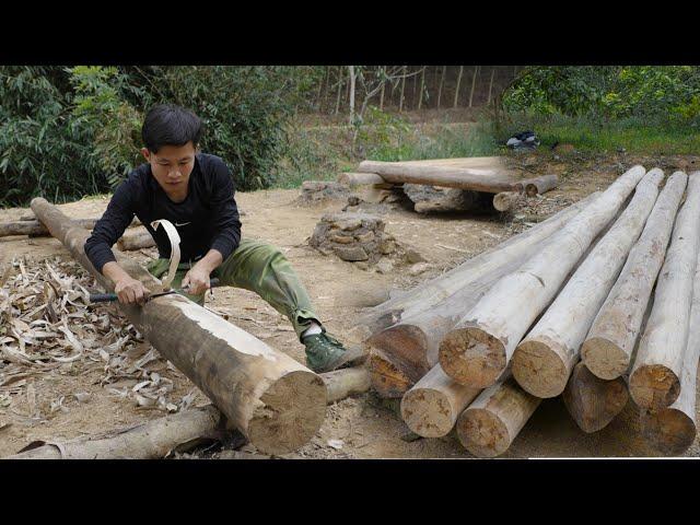 hand planing and shaping wood to build the first wooden wall, Build a log off grid cabin