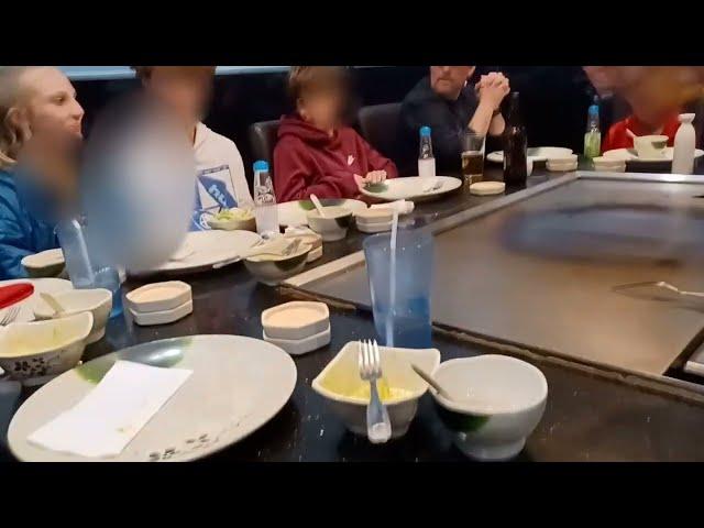 Spraying Sake (Rice Wine) into the mouths of patrons