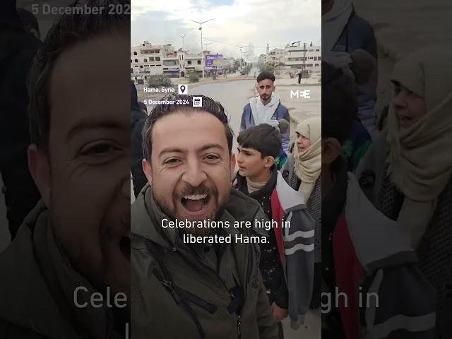 Syrian residents of Hama celebrate as rebel forces take the city