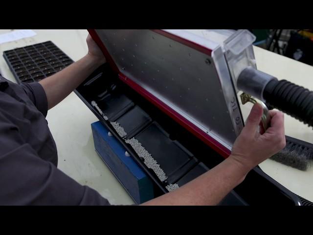 Making seeding trays of flowers and vegetables easier and more efficient.