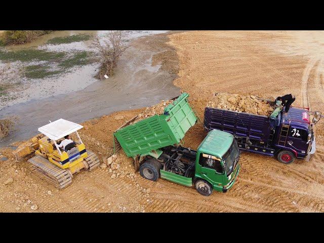 Watch as 5-Ton dump trucks pouring soil for the Komatsu D37P dozer and deleting a pond