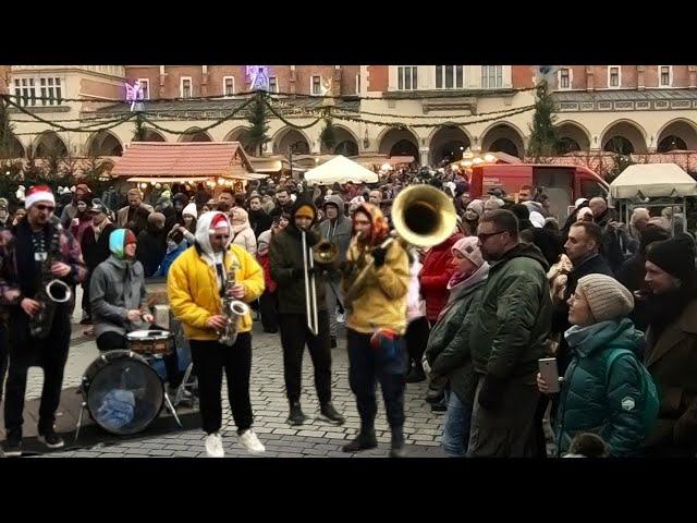 Street Music in Poland. Amazing Band Plays in the Main Square of the Old Town of Kraków