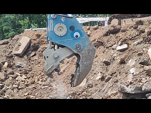 Okada pulverizer munching on concrete.