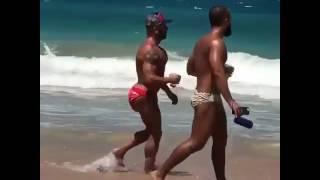 Man with butt injections/implants walks on the beach