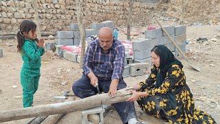 Nargis and the orphan girl: making the shelter wood by Mr. Bahram