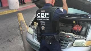 Customs officers inspect vehicles at a Nogales port of entry