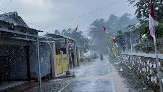 Heavy rain hits villages in Indonesia||walking under the pouring rain||indoculture