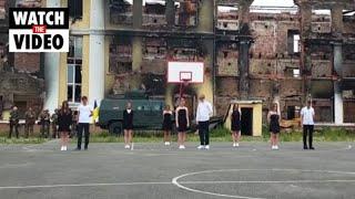 Ukrainian graduates dance in front of destroyed school in Kharkiv