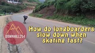 How do longboarders slow down when going fast?