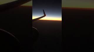 Sunset Sky From Airplane Window. Sunset Over North Pacific Ocean. Sunset on the Horizon.