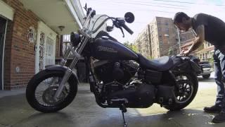 Sexy bikini babe washing Harley-Davidson Street Bob motorcycle