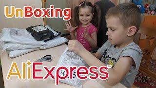 UnBoxing goods from Aliexpress: children's clothing, clothes for boys and girls, women's outfits