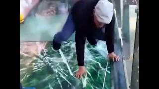 Terrified tour guide freaks out after glass walkway "cracks" under his feet