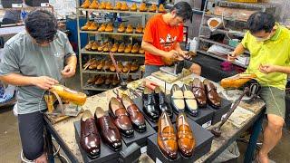 Prozess der Herstellung von LEDERSCHUHEN. VIETNAMESISCHE Arbeiter stellen Luxus-SCHUHE her.