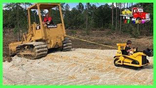 Kruz Helping Dada Powered Ride On Bulldozer Pulling Out The CAT Track Loader Playing Fidget Spinner