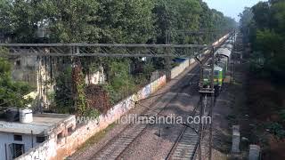 Sewa Nagar Railway station, New Delhi | People on railway track next to running train