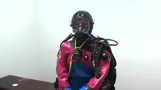 Female Diver is Wearing Viking Rubber Drysuit and Ocean Reef Full Face Mask in Room