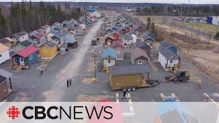 Tiny home village complete after ‘cranking out’ a house a week for 2 years