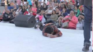 Kid passes out on stage of street performer