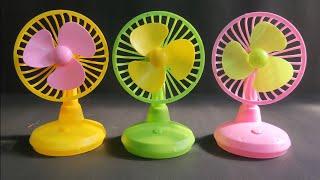 Small Table fans with Green, pink and yellow blades.