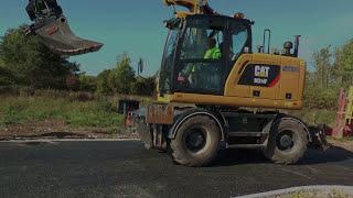 A new CAT excavator M314F rectifies the light poles on a street outside the city Sept 2016