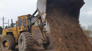 Grading the site soil with big LOADER