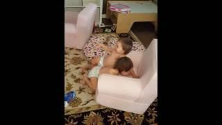 Twin babies hugging and playing