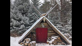 Bushcraft cooking kebabs and roasted veggies over a fire on a winter's day in my permanent shelter