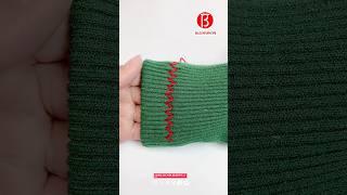 The sleeves of the sweater are too long. Cut them off like this.