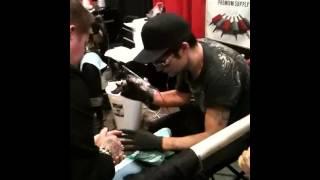 Cory Feldman giving a tattoo