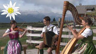 Young music trio play waltz in a perfect mountain setting