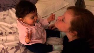 Baby Abigail plays with mom's cheeks