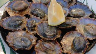 Eating Lapas in Funchal Madeira. Grilled Limpets in Garlic Butter with A Squeeze of Lemon