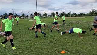 Alex showing his team mates how to do a push up.