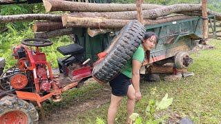 The girl's farm vehicle had a flat tire while transporting timber.