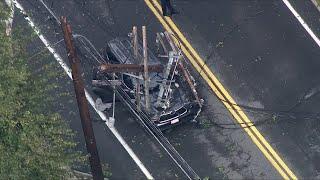 Utility pole falls onto Acton, Massachusetts vehicle on street