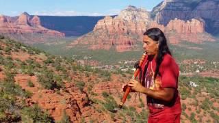 Rahelio playing flute in red