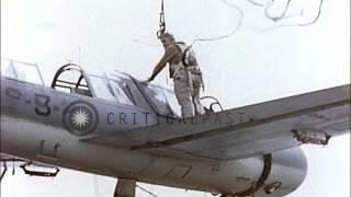 An OS2U Kingfisher floatplane aboard a ship off Iwo Jima is lifted outboard gets ...HD Stock Footage