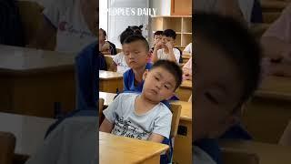 Adorable Chinese boy falling asleep in class