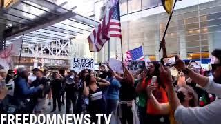 Protesters against vaccine mandates chant "Defund the Media" in front of the New York Times building