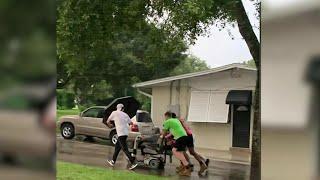 ‘I was so moved:’ Young men push woman on broken-down scooter back home in the rain